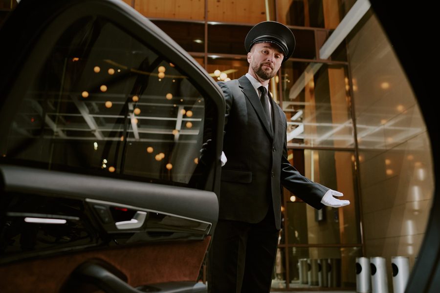Uniformed chauffeur ready for London airport transfer service